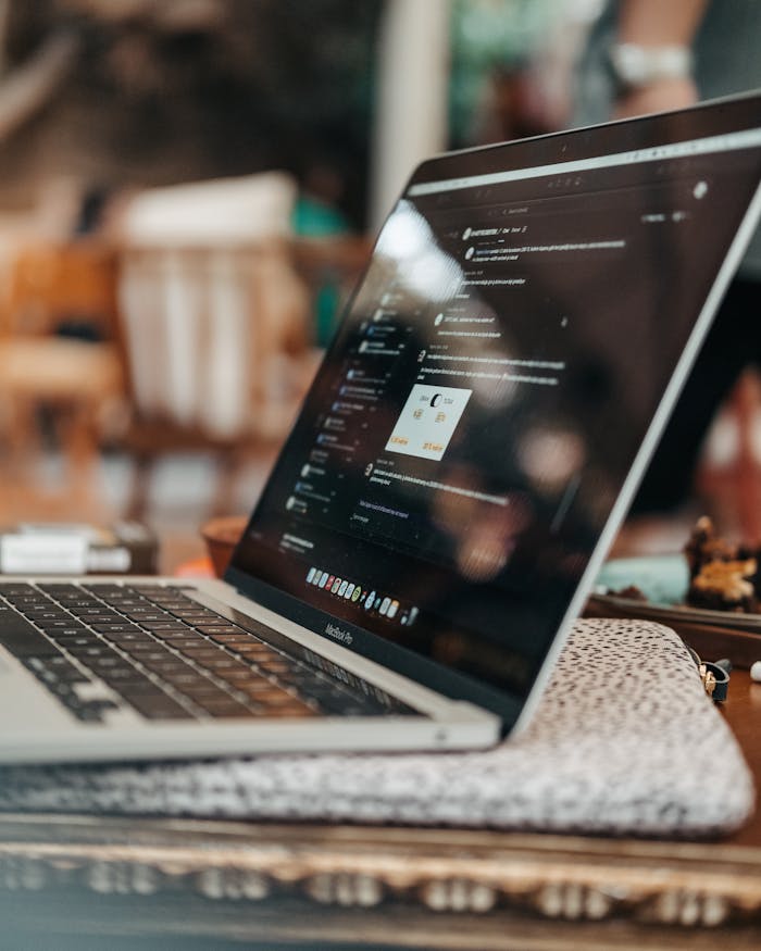 Modern laptop placed on a desk in a casual indoor workspace. Ideal for tech and work-from-home themes.